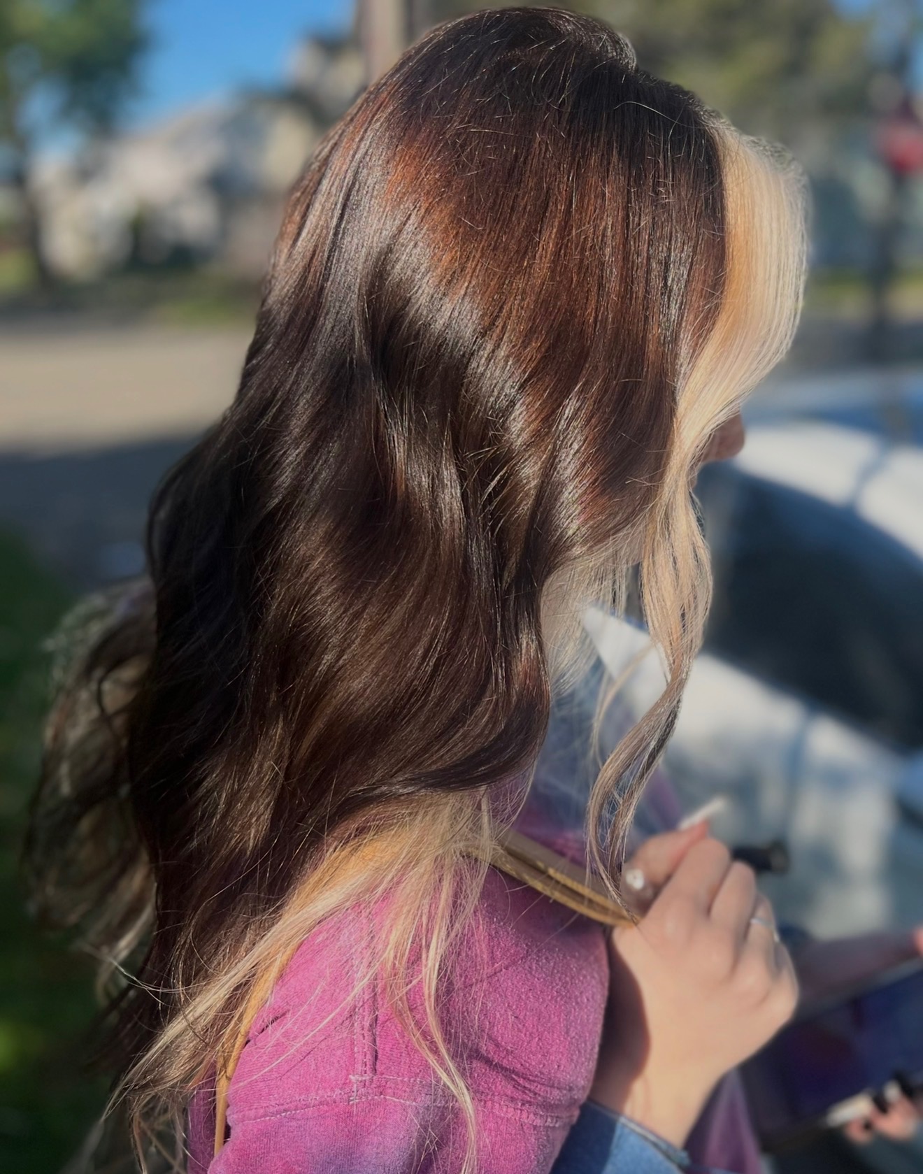 Brunette with blonde money piece face-framing highlights